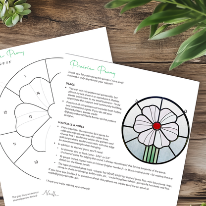 Two pages of the prairie peony pattern on a wood table with plants.