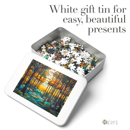 A white metal tin with an open lid displays high-quality chipboard pieces. The lid features a stained glass artwork of a colorful forest scene, river, and sun. Text reads, White gift tin for easy, beautiful presents. Ideal for gifting the Stained Glass Rainbow Forest Jigsaw Puzzle experience.