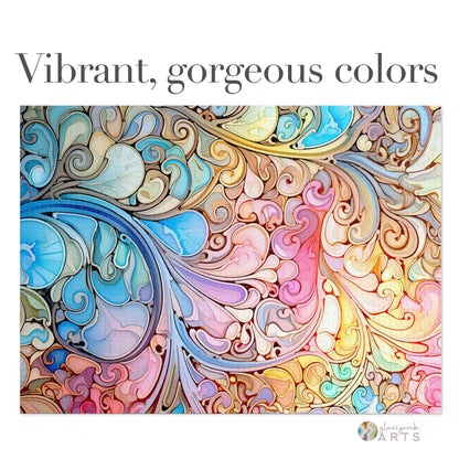 The Stained Glass Rainbow Paisley Jigsaw Puzzle features an intricate abstract pattern with swirling shapes in blue, pink, yellow, and brown. This design resembles leaves and waves, reminiscent of stained glass art, with the text: Vibrant, gorgeous colors.