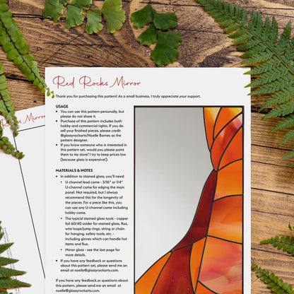 Two pages of the red rocks mirror pattern on a wood table with ferns.