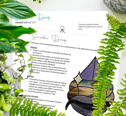 A page titled Snake Stained Glass Pattern Rain Drop features instructions, partly hidden by green ferns. It showcases a mystical stained glass leaf design with usage notes for small businesses and a glassgarden ARTS watermark in the corner.