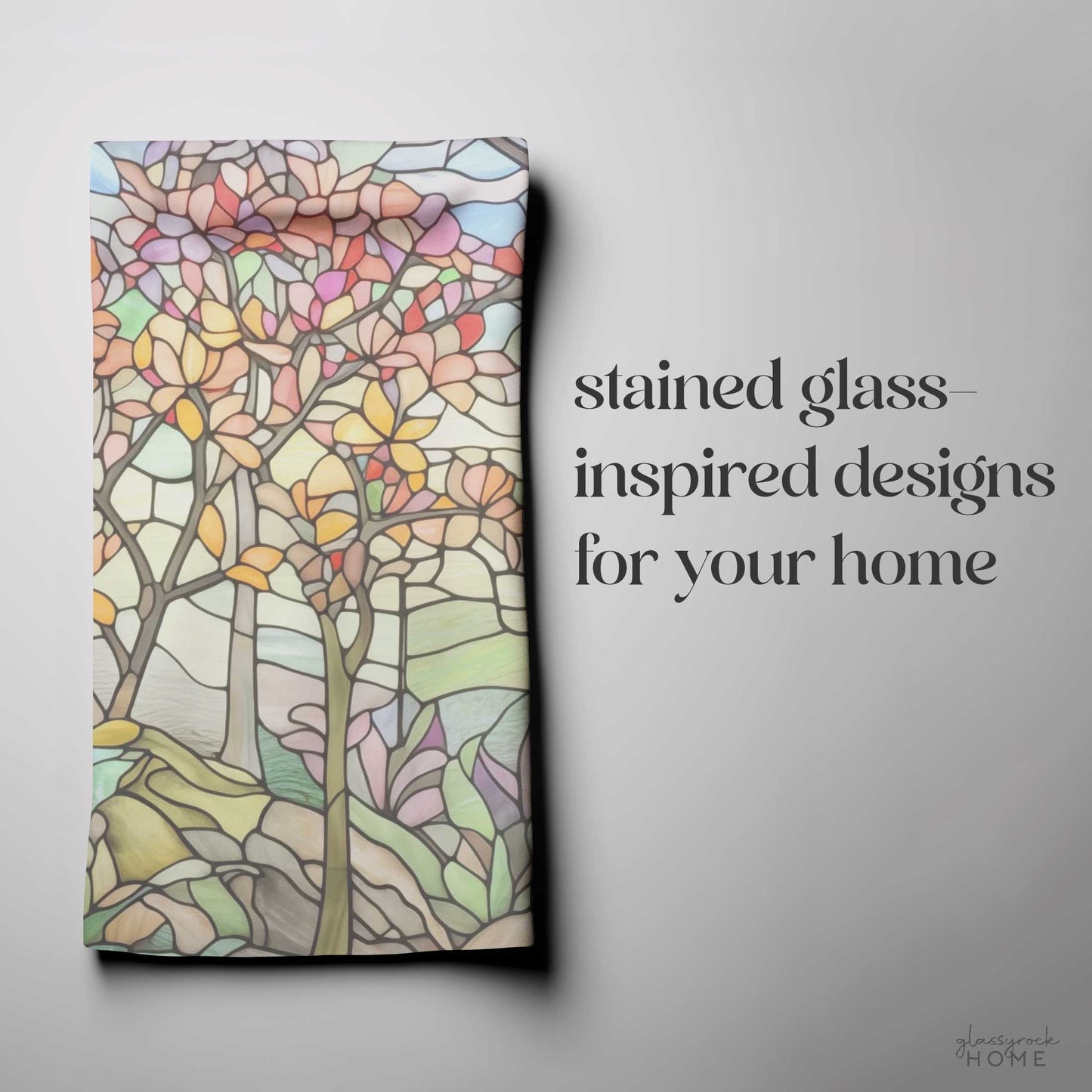 The Stained Glass Spring Forest Dish Towel is a colorful kitchen decor piece featuring stained glass-inspired abstract tree and floral designs. The text reads stained glass-inspired designs for your home, with a signature, ideal for vibrant kitchen tea towels.