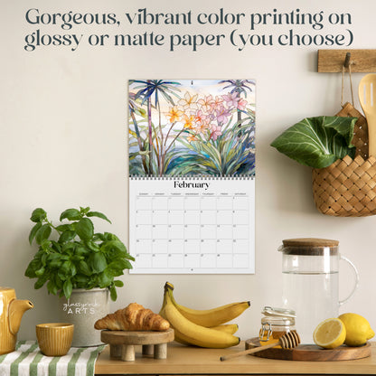 The 2025 Wall Calendar - Stained Glass Tropical Blooms, showcasing beautiful tropical flower illustrations in a stained glass style, is displayed in a kitchen setting adorned with various plants, fruits, and kitchenware. The text above indicates options for glossy or matte high-quality paper printing.