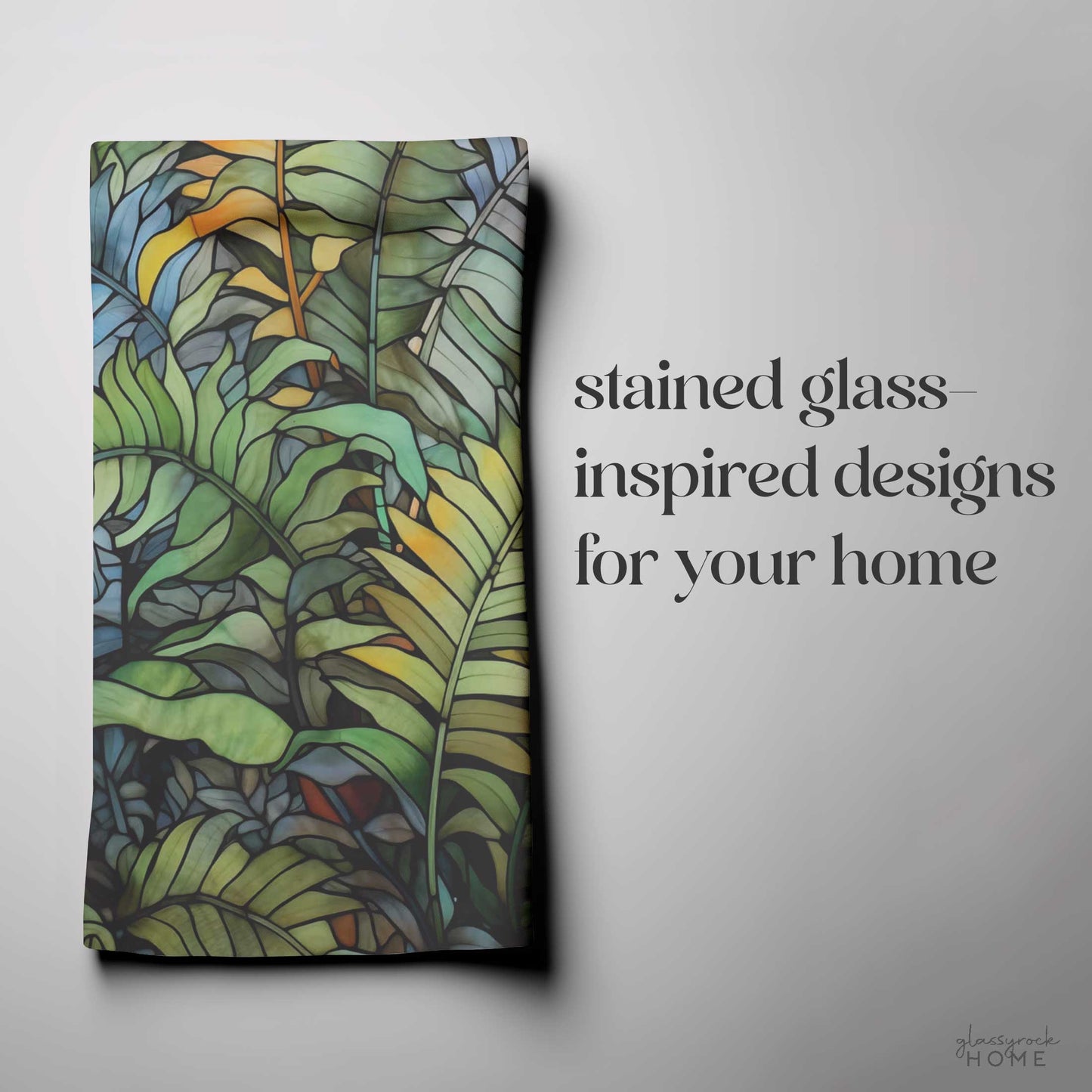 A light gray dish towel with a stained glass-inspired pattern of green fern-like leaves, named Stained Glass Wild Ferns. Text on the right reads Stained glass-inspired designs for your custom creation, perfect for a unique kitchen towel design.