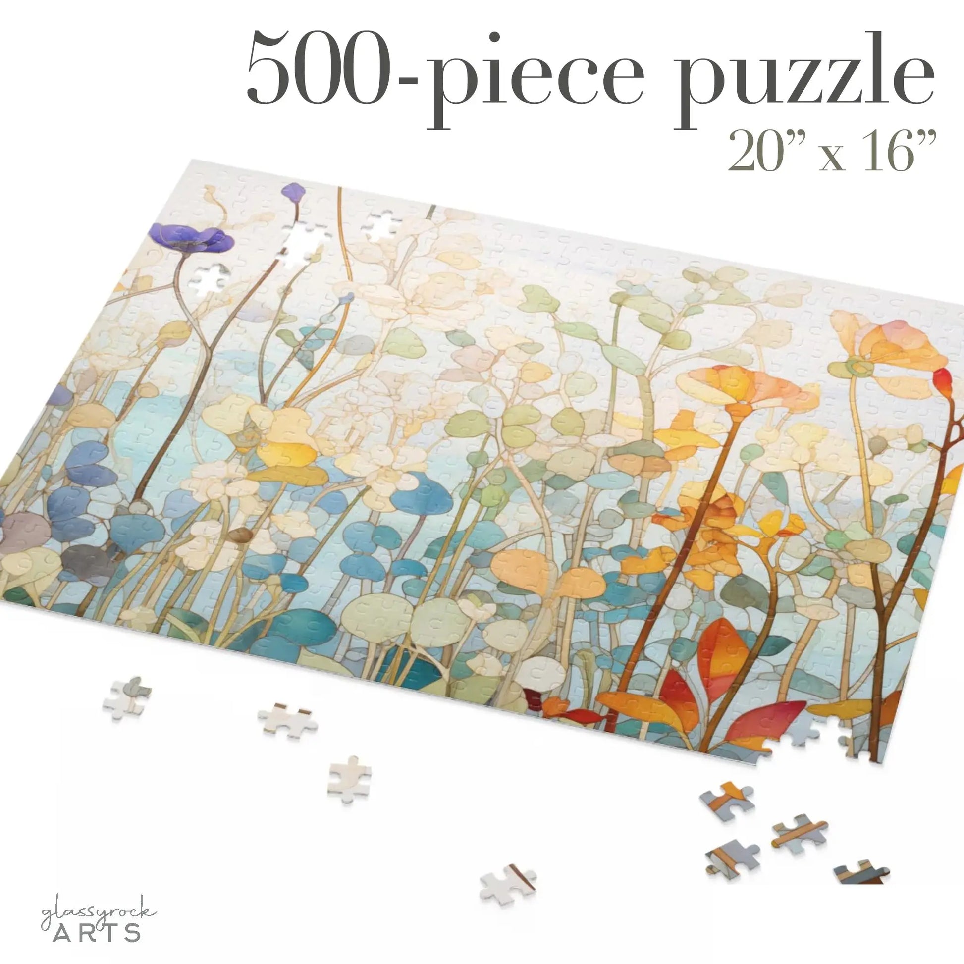 A partially completed Wildflower Botanicals Jigsaw Puzzle (500 pieces) showcases a colorful, abstract floral design on a light blue backdrop. Loose pieces lie around the incomplete areas. Text reads 500-piece puzzle, 20” x 16”.