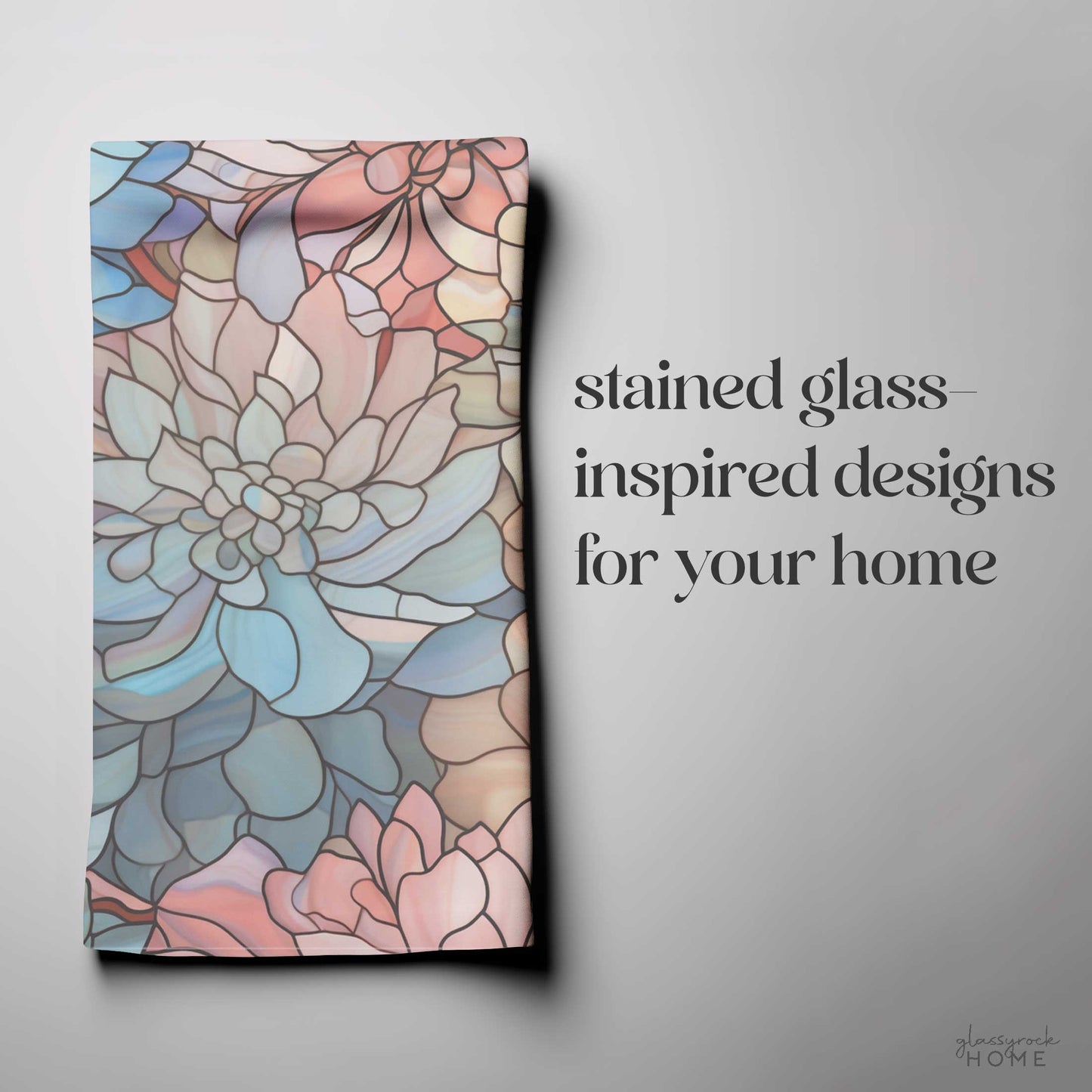 A folded fabric displays a vibrant stained glass-inspired floral design in pastels, with text beside it saying Stained Glass Dark Flowers Dish Towel for your home, making it the perfect housewarming gift. A small logo sits at the bottom right.