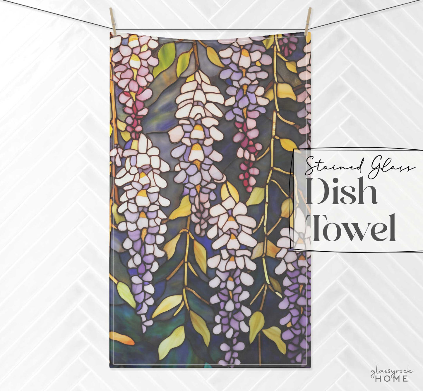 Hanging dish towel with a stained glass design featuring cascading wisteria flowers in purple, white, and yellow hues. This natural cotton twill kitchen towel reads: "Stained Glass Wisteria Dish Towel" by Lacework Home.