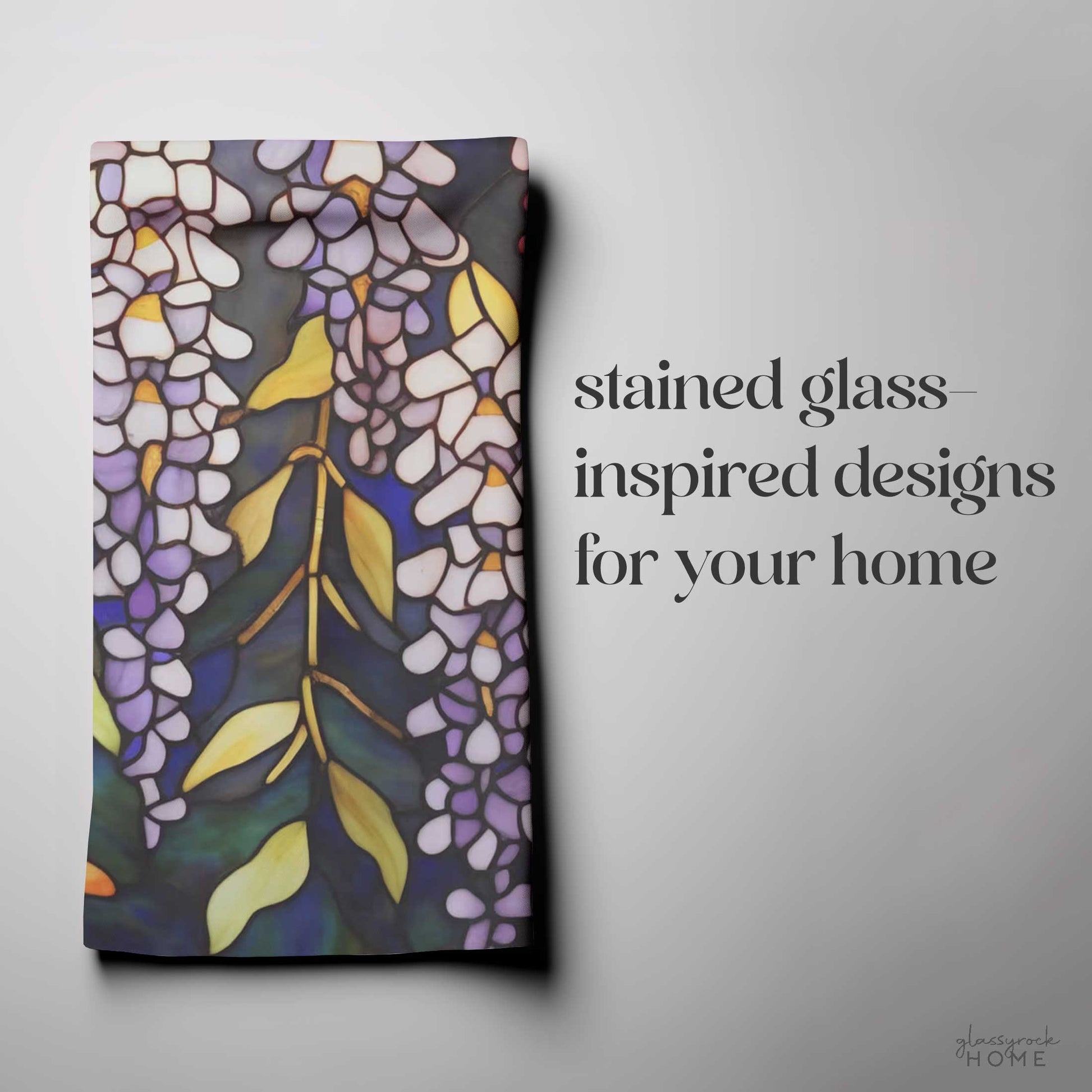 The Stained Glass Wisteria Dish Towel, showcasing a floral pattern inspired by stained glass designs, is displayed next to the text: "stained glass-inspired designs for your home" in natural cotton twill.