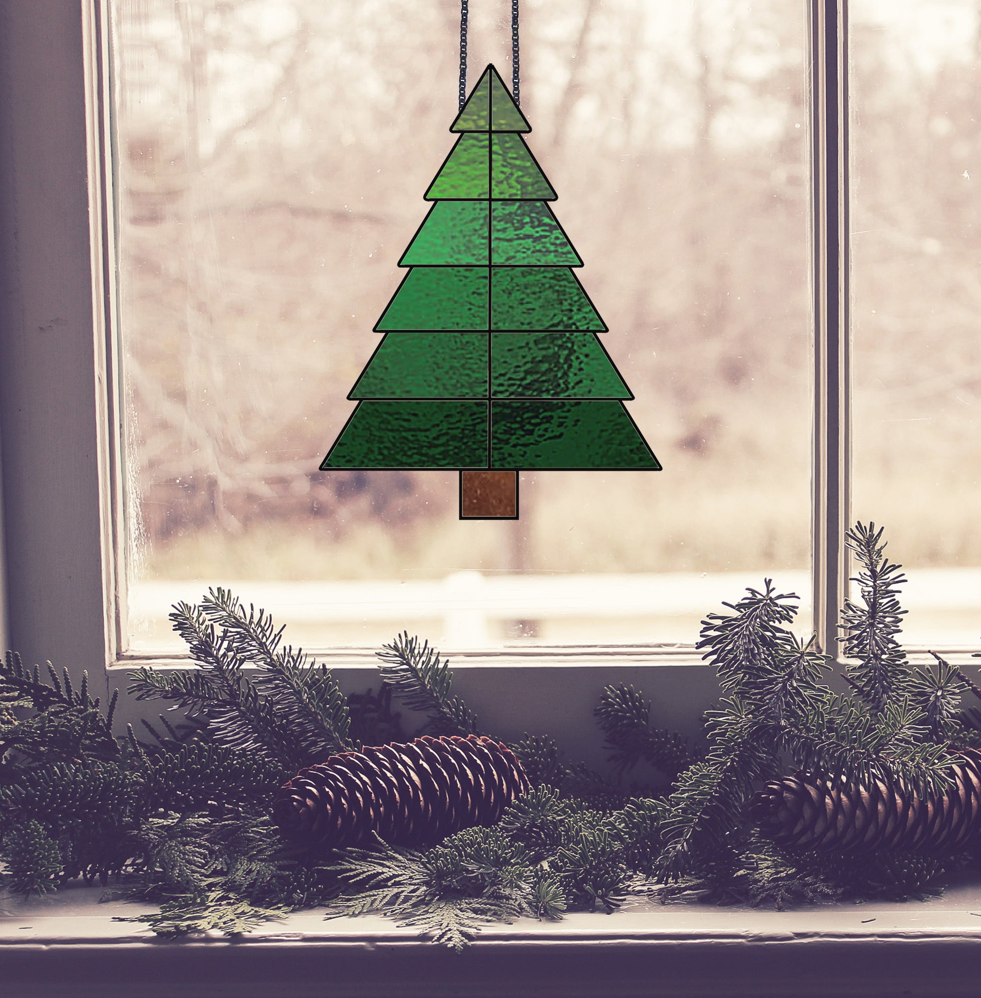 Beginner stained glass pattern for a Christmas tree, instant PDF download, shown hanging in a window with pine cones