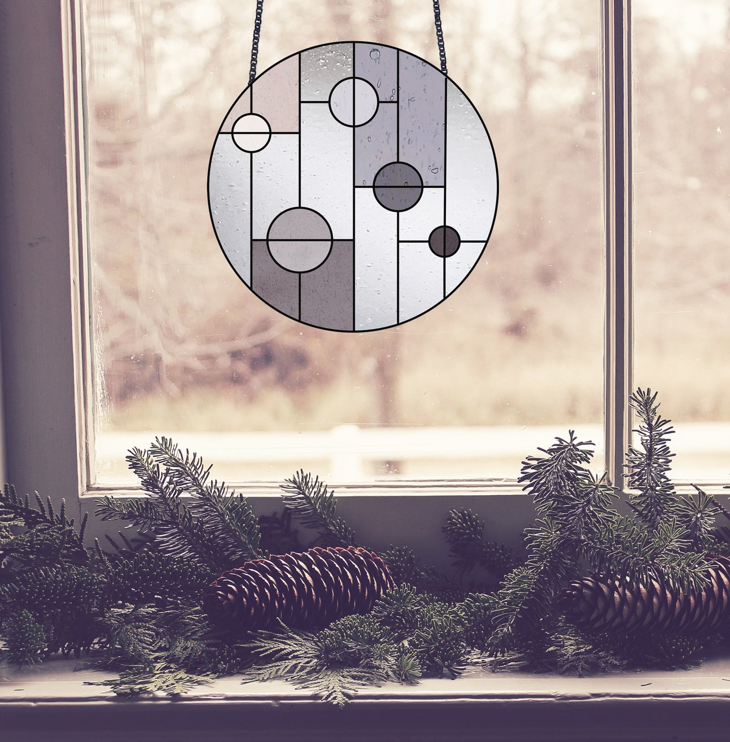 Geometric circle stained glass pattern, instant PDF download, shown in a window with pine cones
