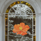 Stained glass pattern for a giant cosmos flower, instant PDF download, shown hanging in an old window with plants behind it