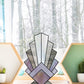 Beginner feather, standing stained glass pattern, shown in a windowsill with a wintry background