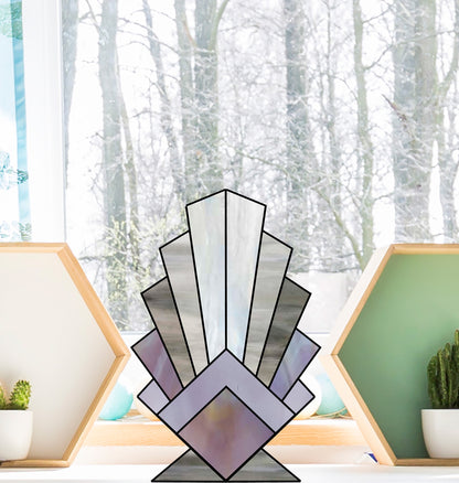 Beginner feather, standing stained glass pattern, shown in a windowsill with a wintry background