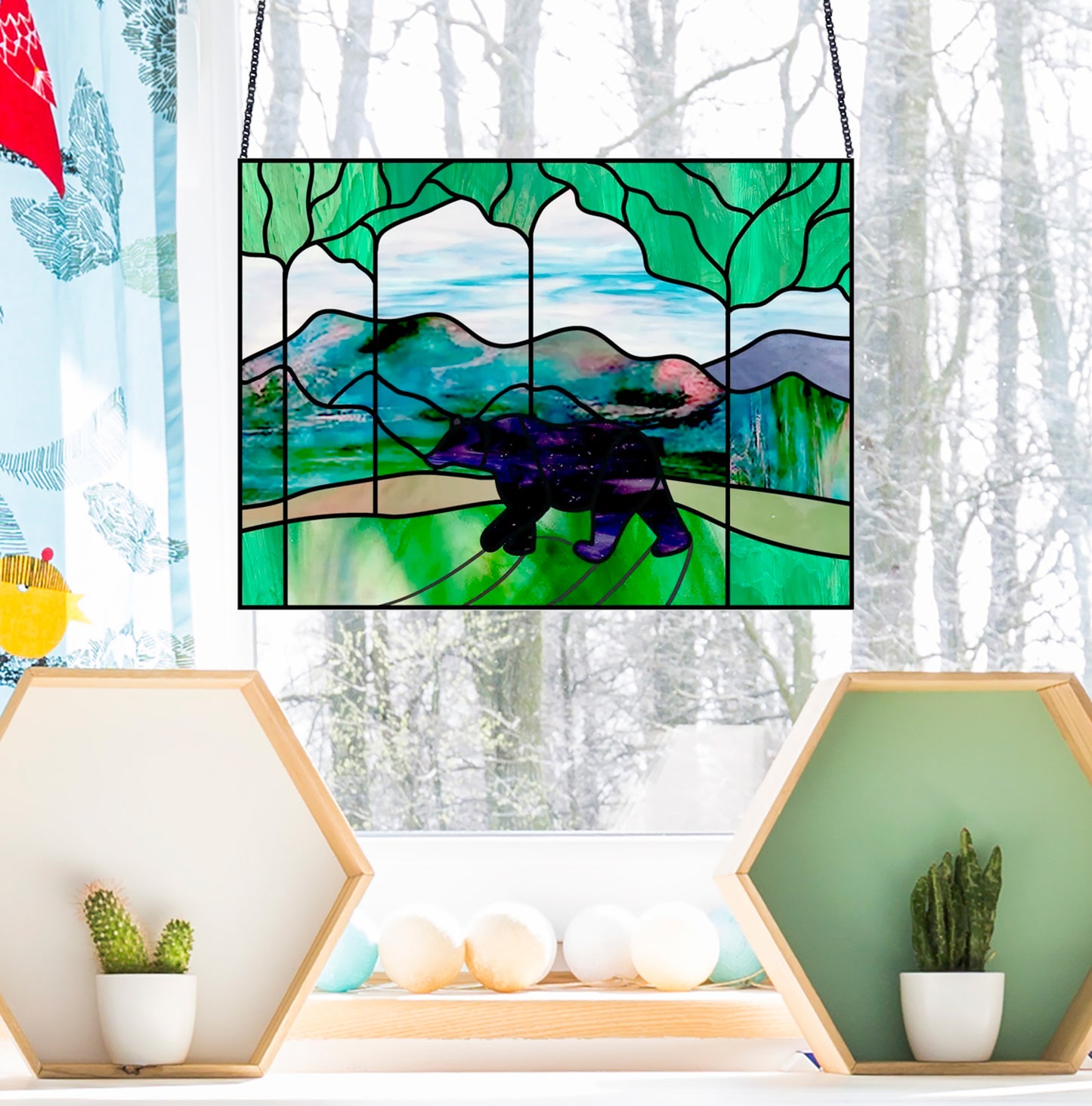 Bear in the forest stained glass pattern, instant pdf, shown in window with winter background