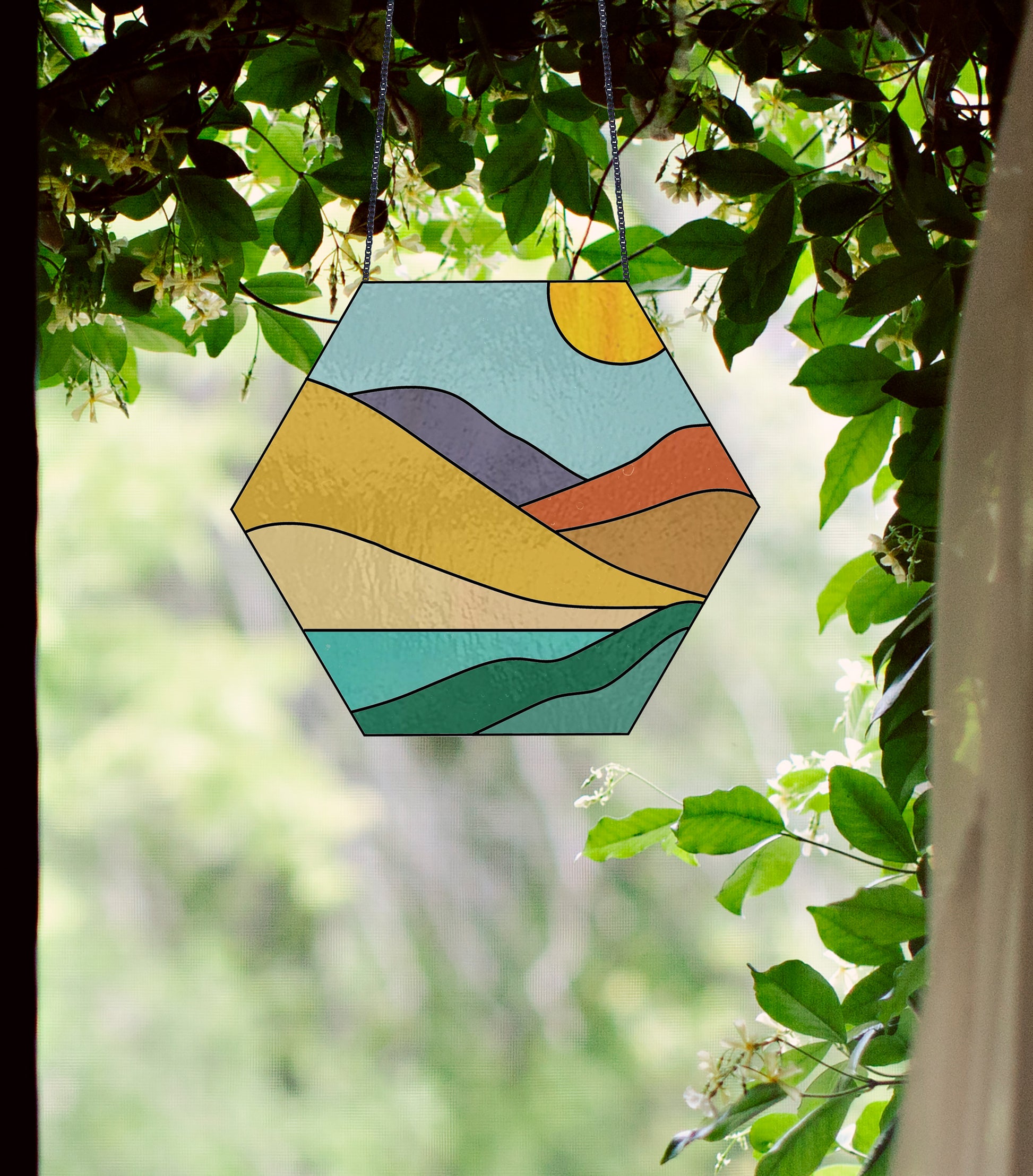 Stained glass pattern for a boho landscape hexagon, instant PDF download, shown in a window with ivy