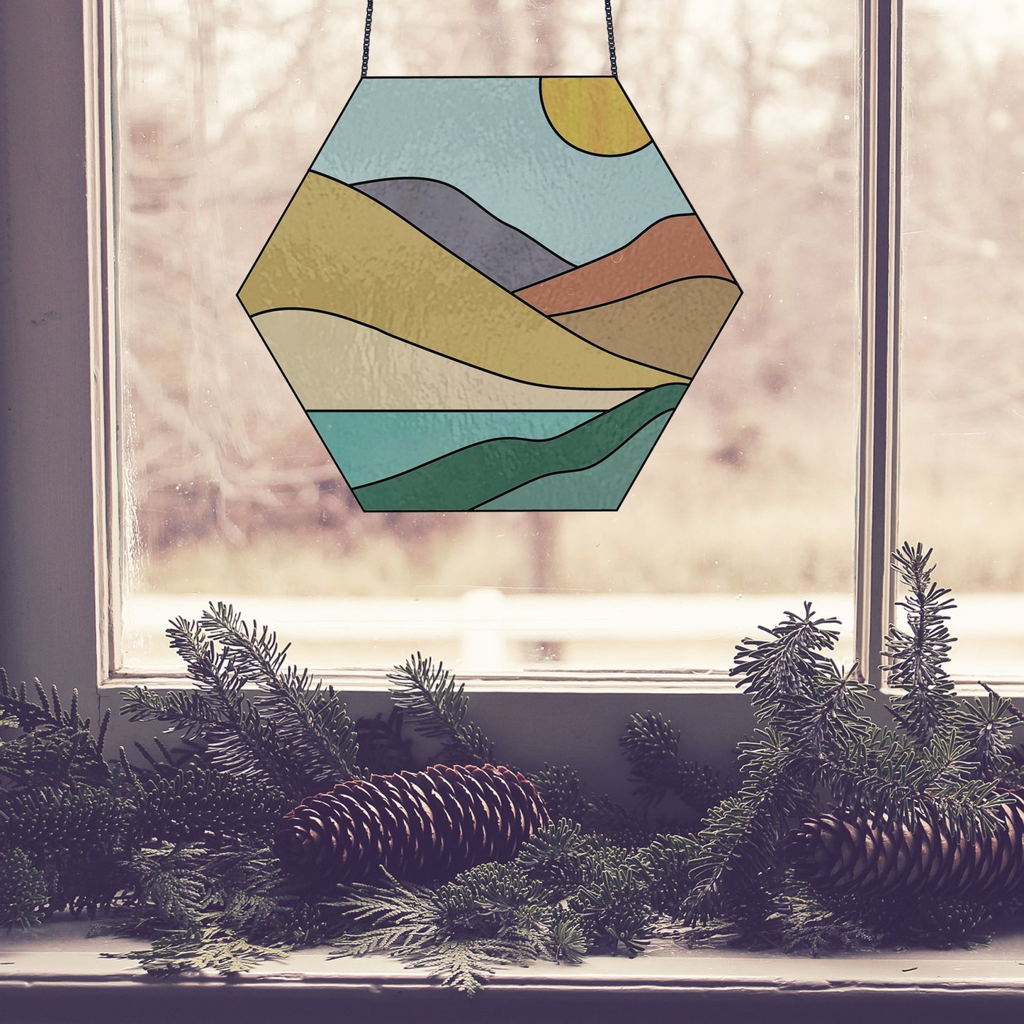 Stained glass pattern for a boho landscape hexagon, instant PDF download, shown in a window with pine cones
