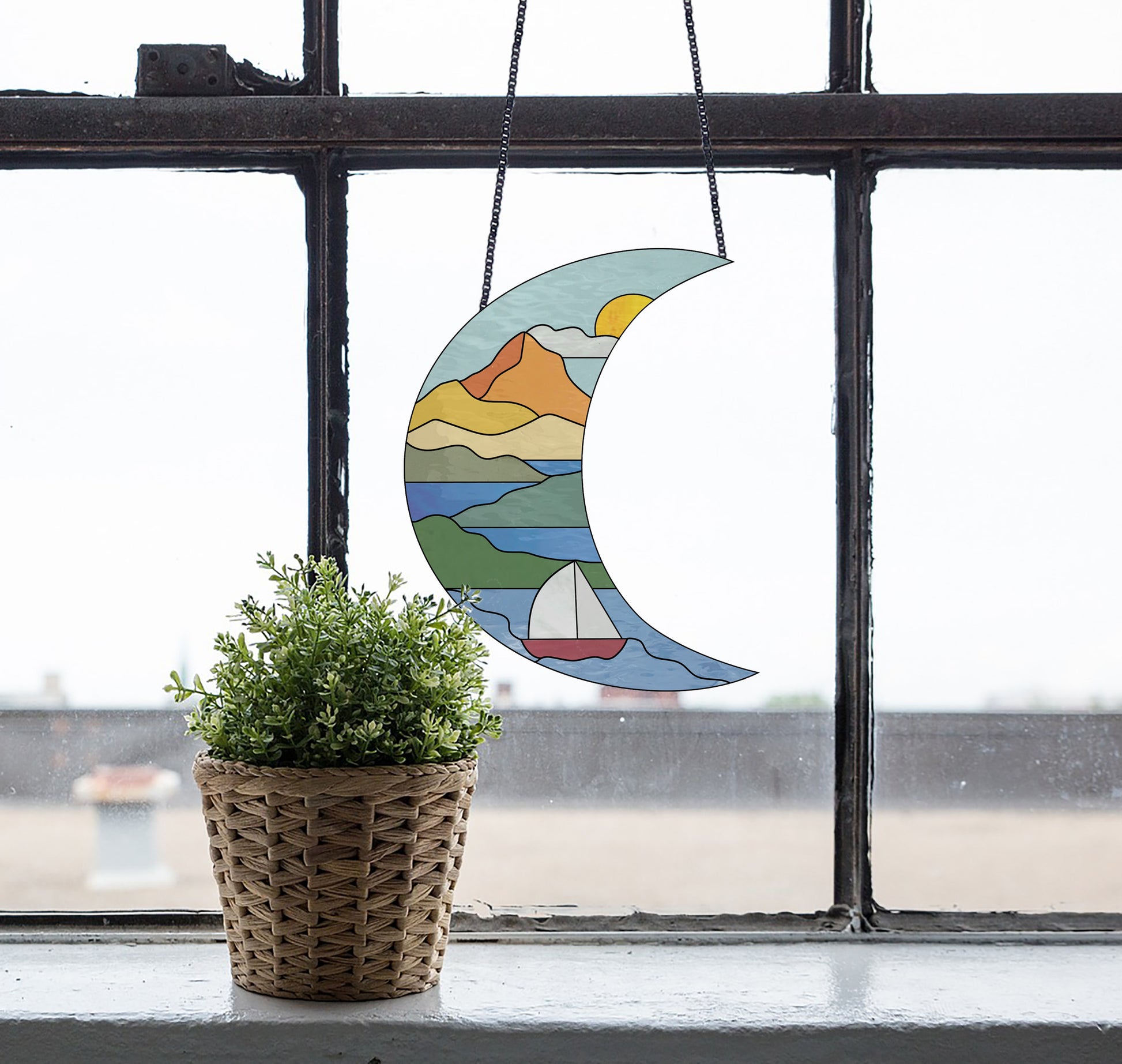 Stained glass pattern for a boho seascape crescent moon, instant PDF download, shown in a window with a plant