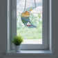 Stained glass pattern for a boho seascape crescent moon, instant PDF download, shown in a window with a plant