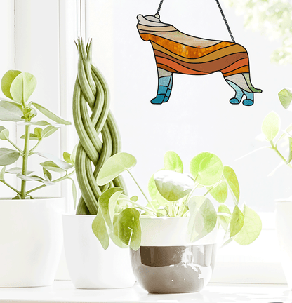 Boho Lioness stained glass pattern, instant PDF download, shown in a window with plants