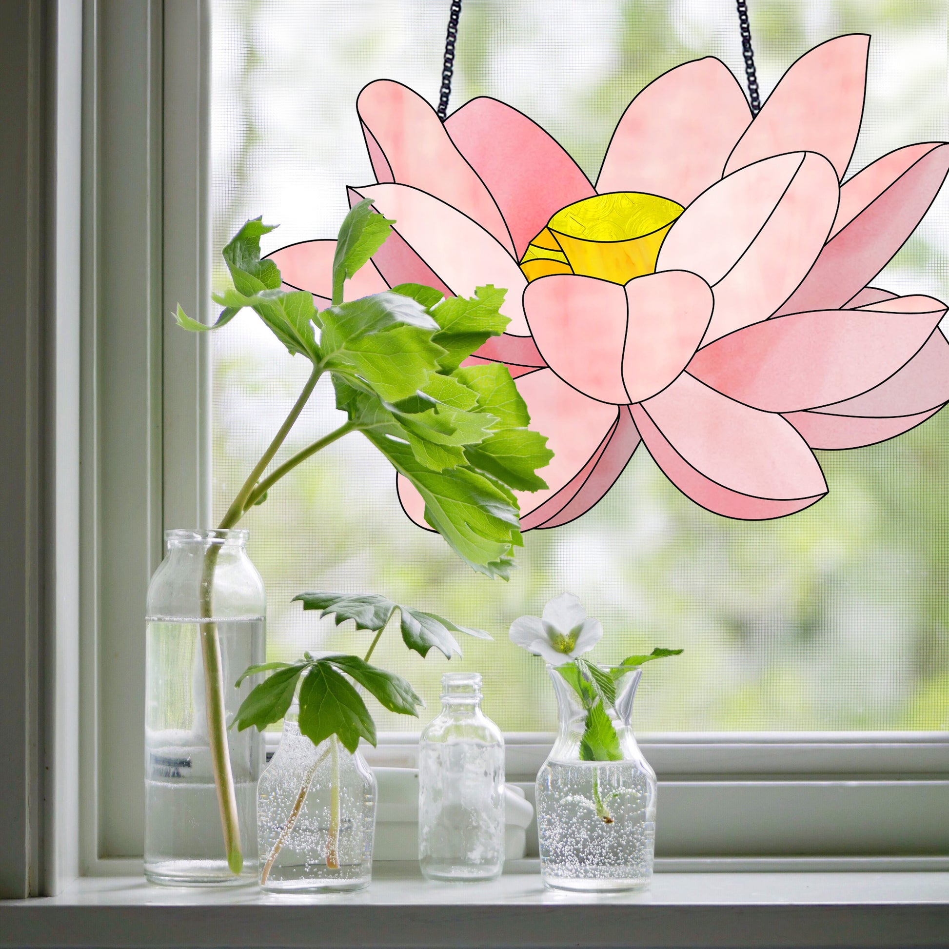 lotus stained glass pattern, instant pdf download, shown hanging in a window with bottles and plants