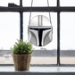 The Mandalorian Star Wars helmet stained glass pattern, instant pdf download, shown in window with plant
