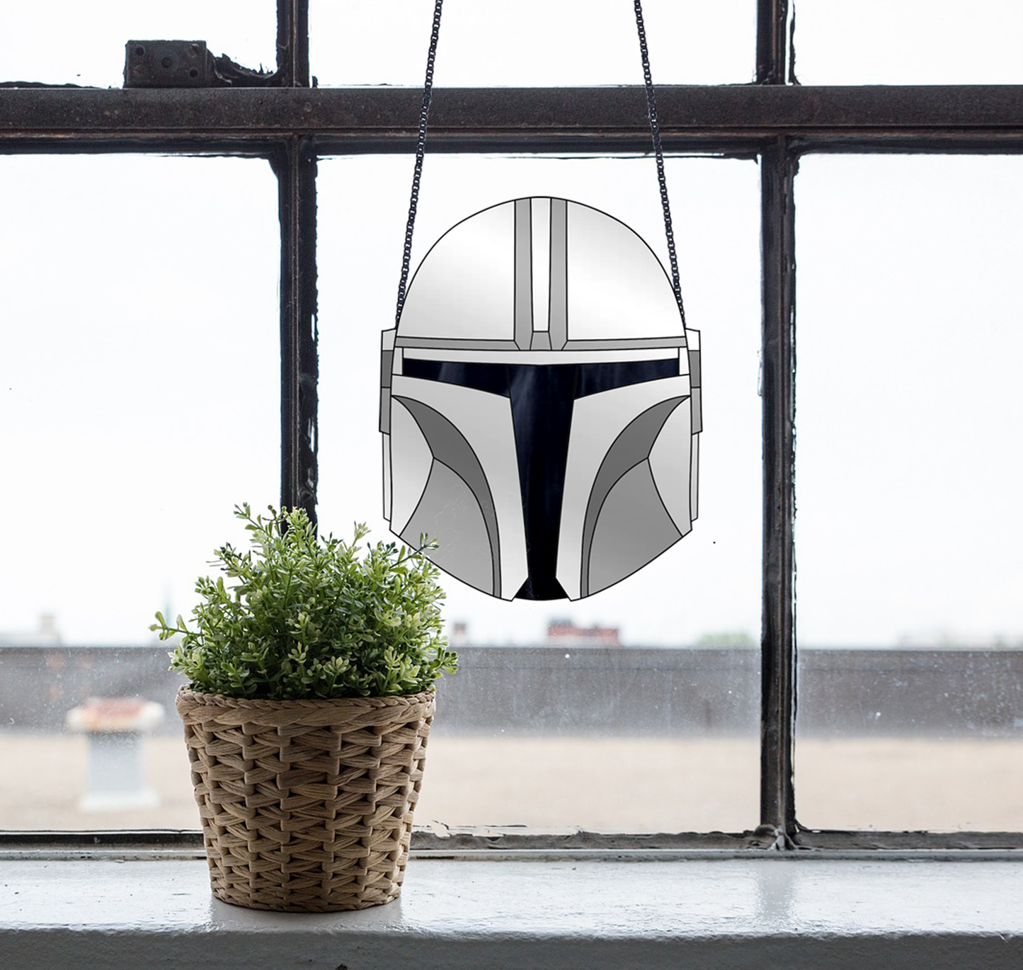 The Mandalorian Star Wars helmet stained glass pattern, instant pdf download, shown in window with plant