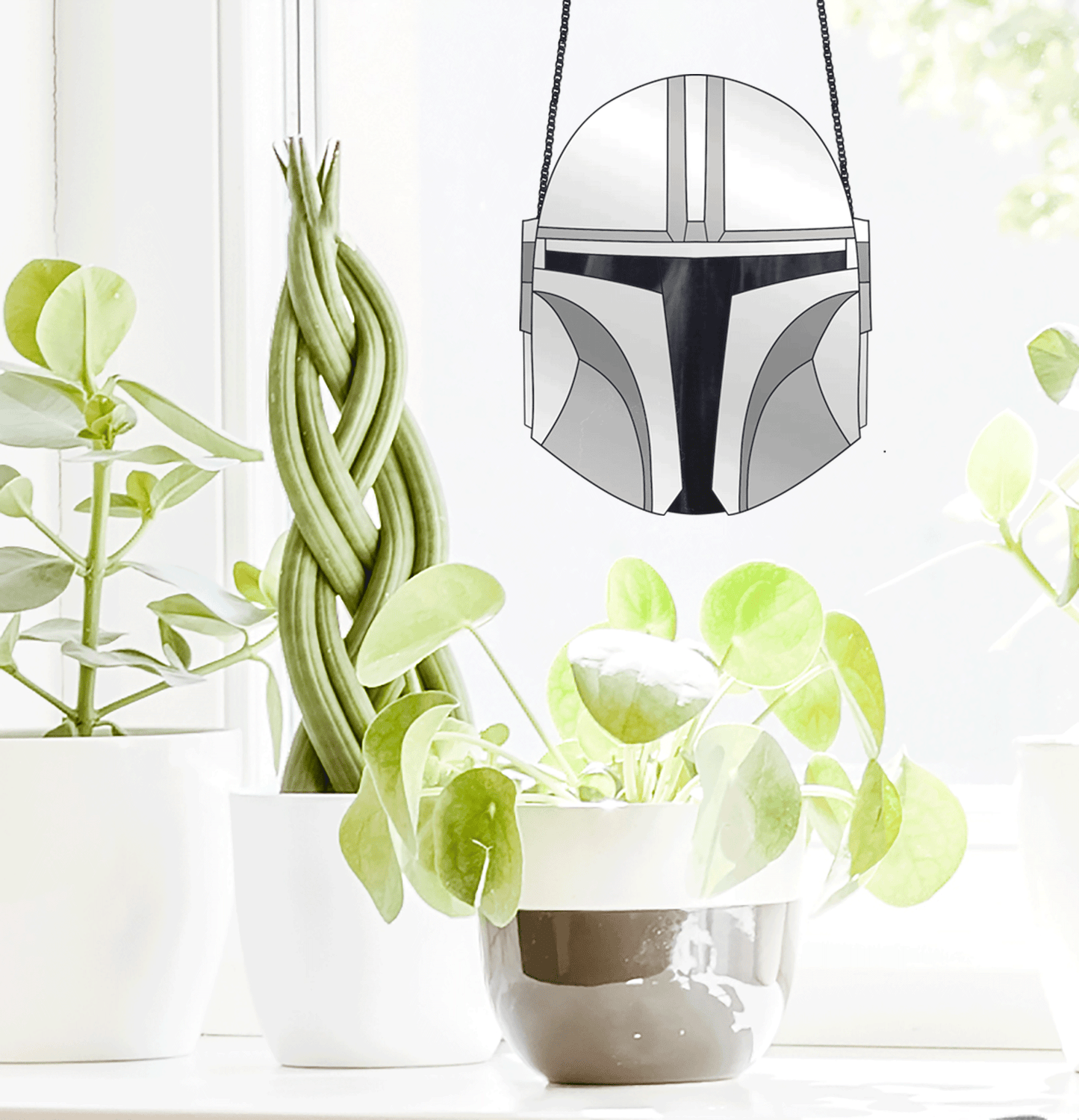 The Mandalorian Star Wars helmet stained glass pattern, instant pdf download, shown in window with plants