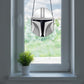 The Mandalorian Star Wars helmet stained glass pattern, instant pdf download, shown in window with plant