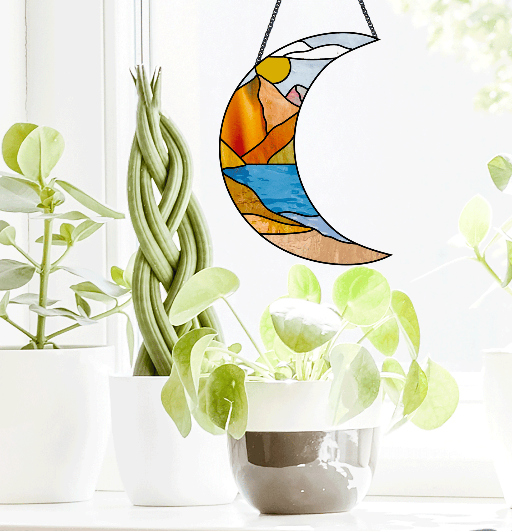 Stained glass pattern for a boho landscape crescent moon, instant PDF download, shown in a window with plants
