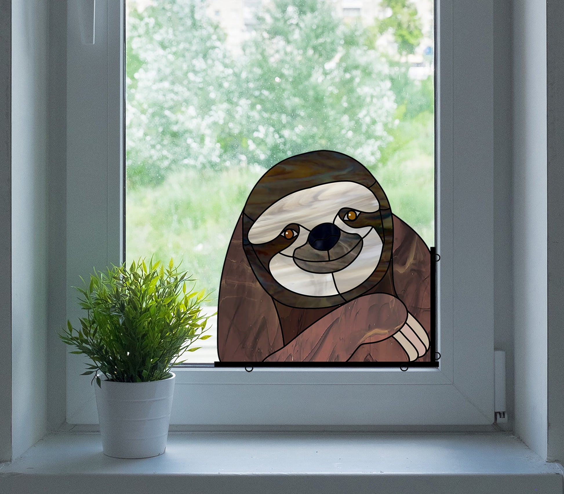 Stained glass pattern for a sloth peeking in the window, instant PDF download, shown in a window with a plant