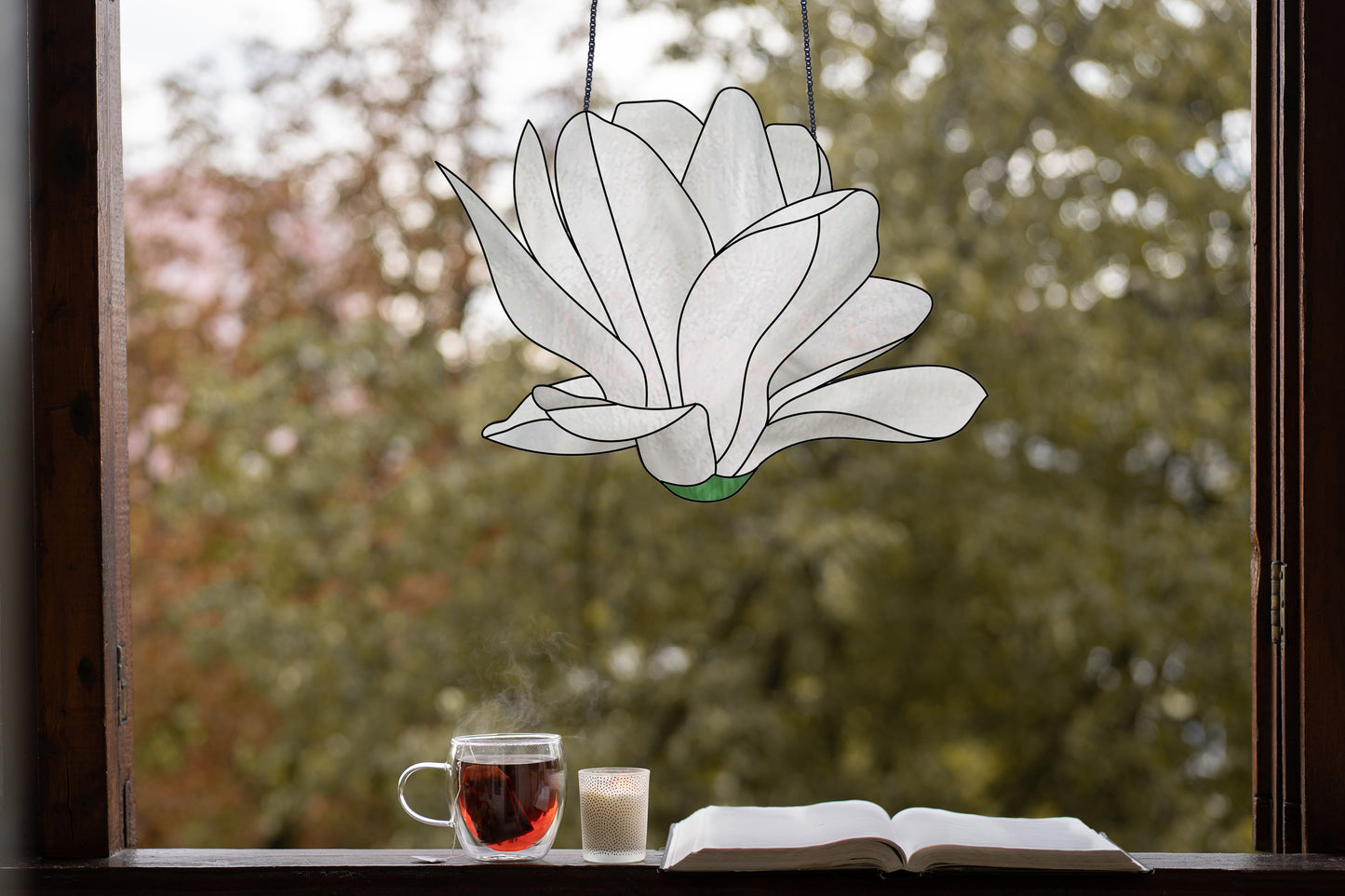 Stained glass pattern for a giant white snowdrop flower, instant PDF download, shown hanging in a window with a cup of tea and a book