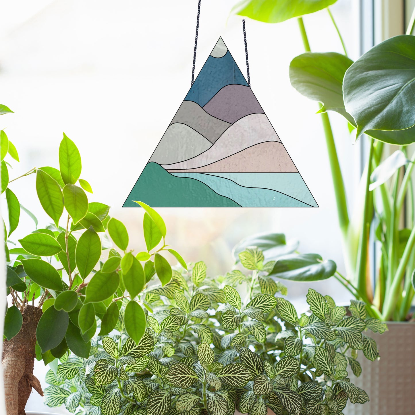 Triangle stained glass pattern for a boho landscape, instant PDF download, shown in a window with plants