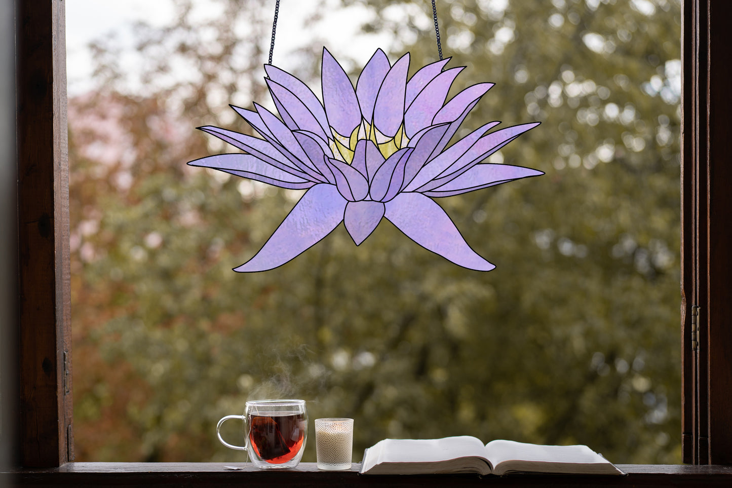 Stained glass pattern for a giant purple water lily flower, instant PDF download, shown hanging in a window with tea and a book